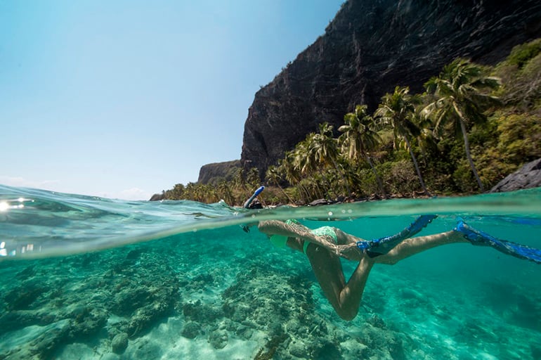 A woman snorkeling off the shore of Playa Fronton, Dominican Republic