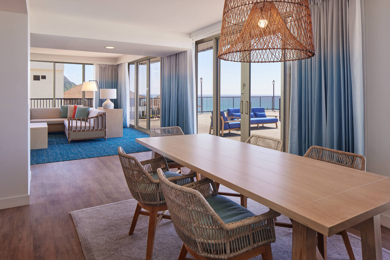 Hotel living and dining area with ocean view 