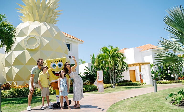 A family poses with SpongeBob SquarePants outside the Pineapple Villa at Nickelodeon Hotels & Resorts Punta Cana