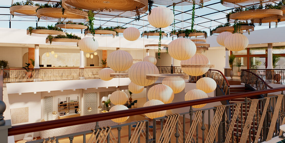 Upper story view of hotel lobby with skylights above and hanging pendant spheres in the center