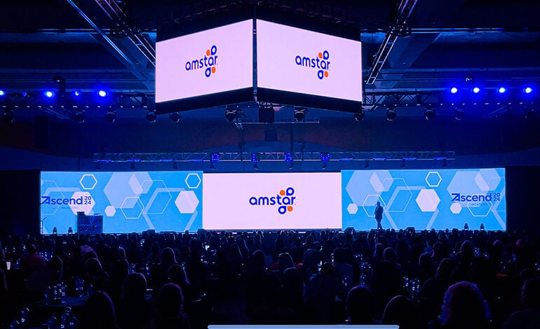 The new Amstar logo shows on three screens at the 2024 Ascend by ALG Vacations conference.