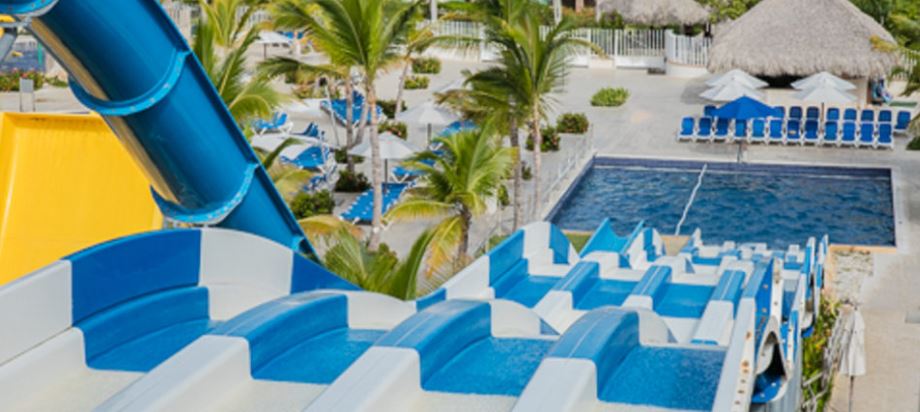 Three side by side waterslides into a pool