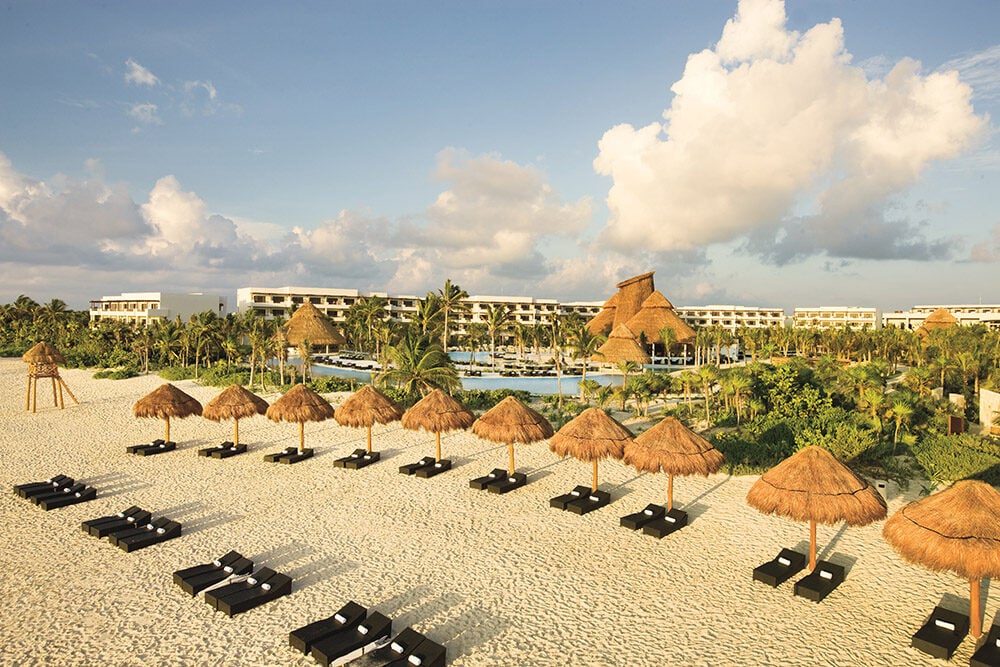 Beach loungers and umbrellas at Secrets Maroma Beach Riviera Cancun.